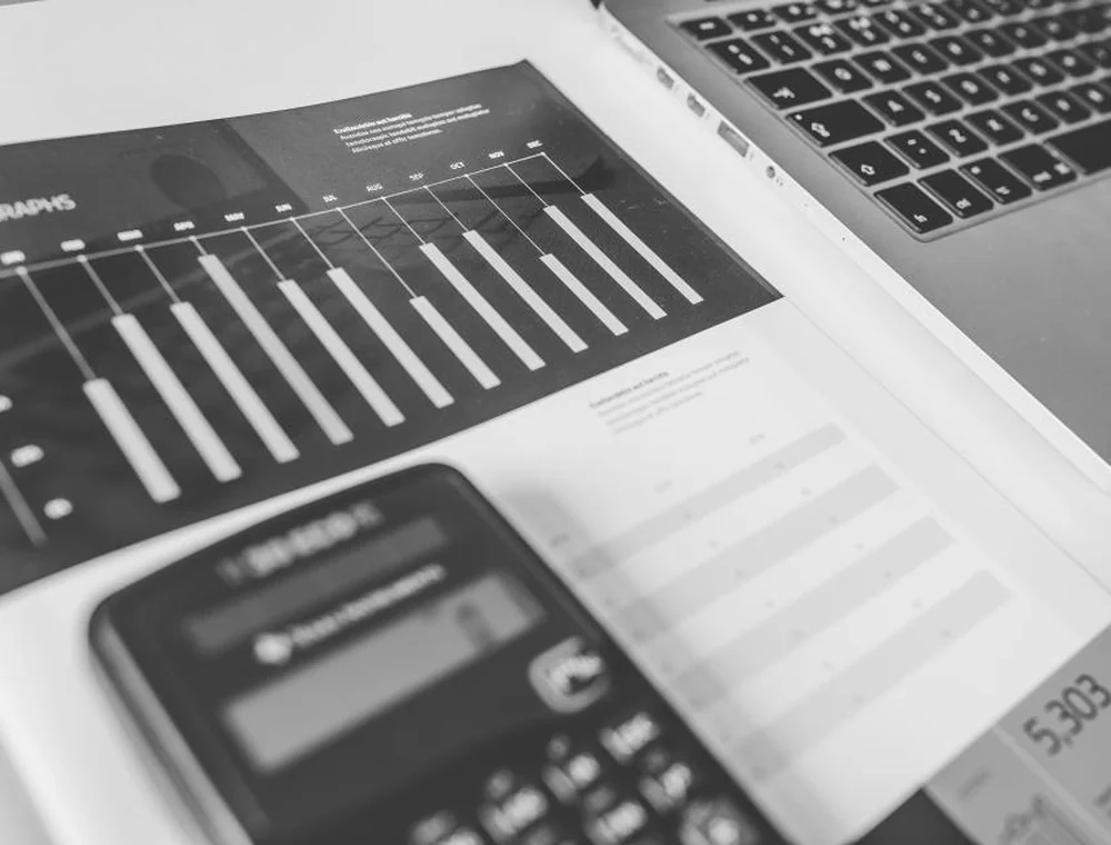 Calculator and financial paperwork on a desk